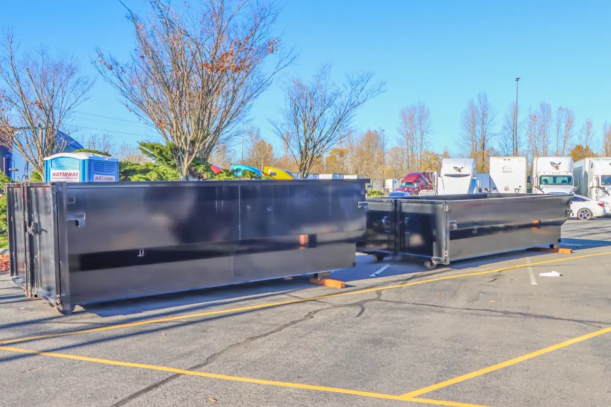 Professional dumpster rental service with roll-off container on residential driveway in Dania Beach